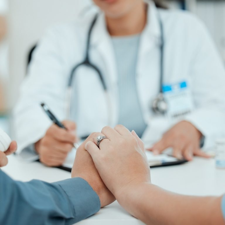 Hospital,,Holding,Hands,And,Doctor,With,Couple,For,Consulting,,Wellness